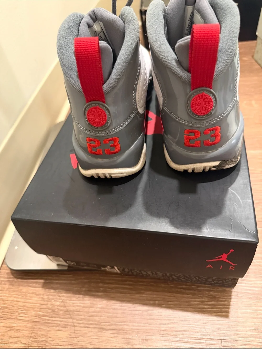 White and Gray Athletic Sneakers with Red Accents